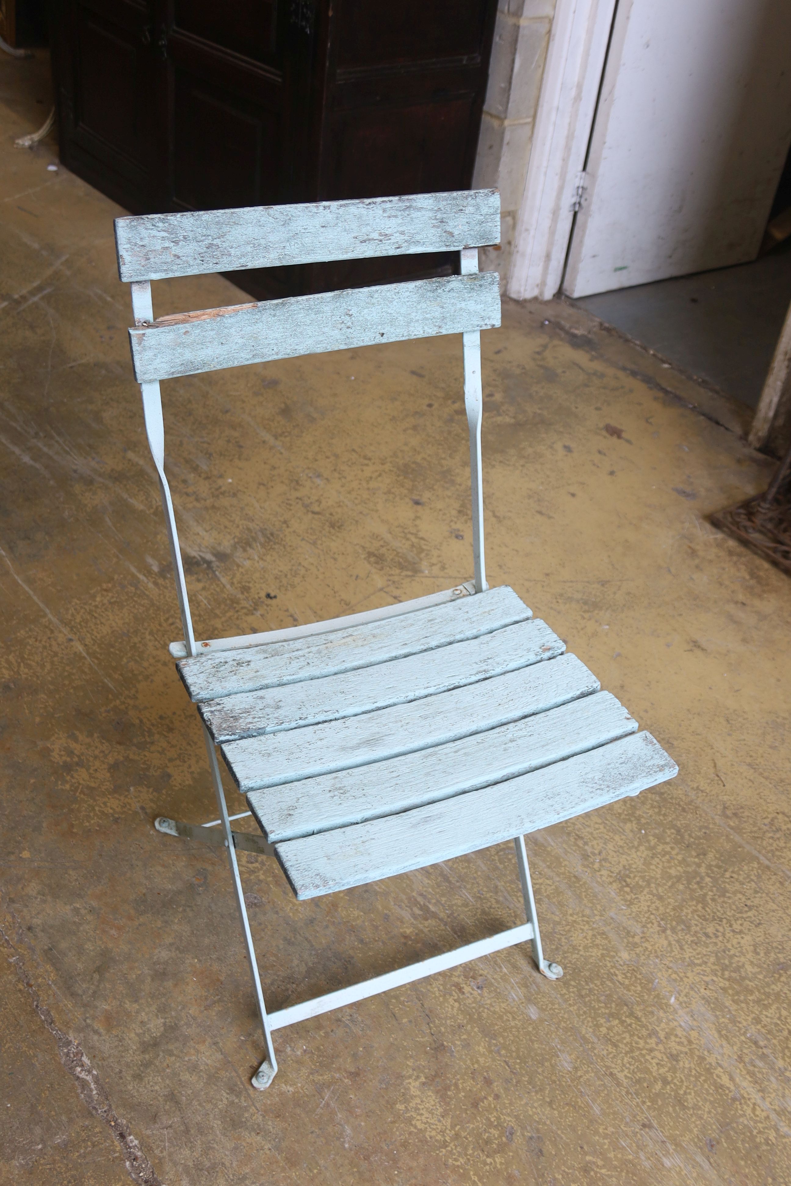 A set of four slatted metal folding garden chairs